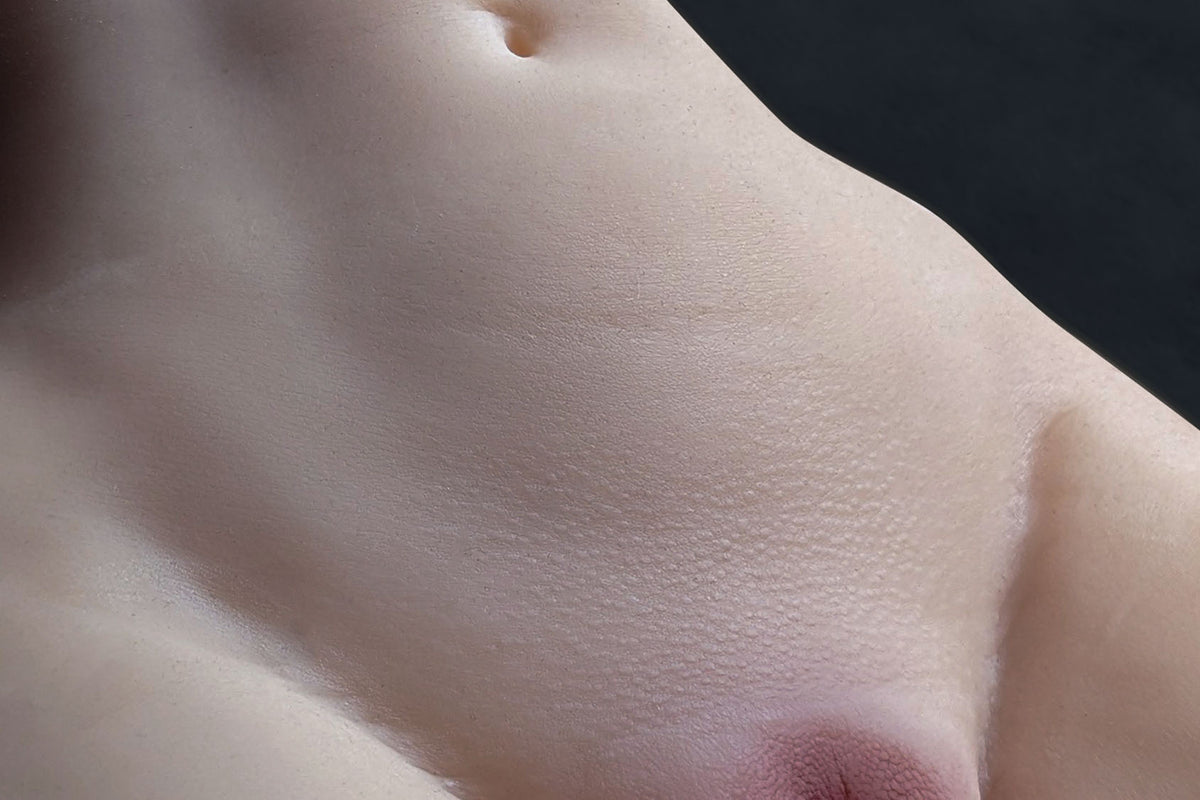 Close-up of the skin texture of sex doll Sara with navel and pore details
