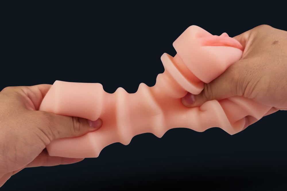 Two hands stretching the flexible inner sleeve of Mila masturbator